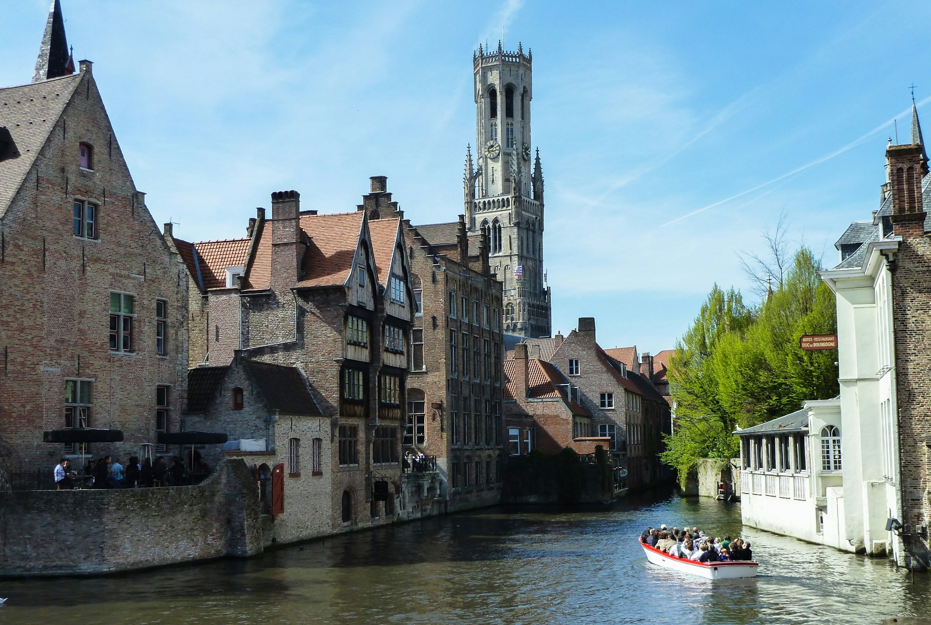 Canal boat tour in Bruges Belgium with Belfry tower