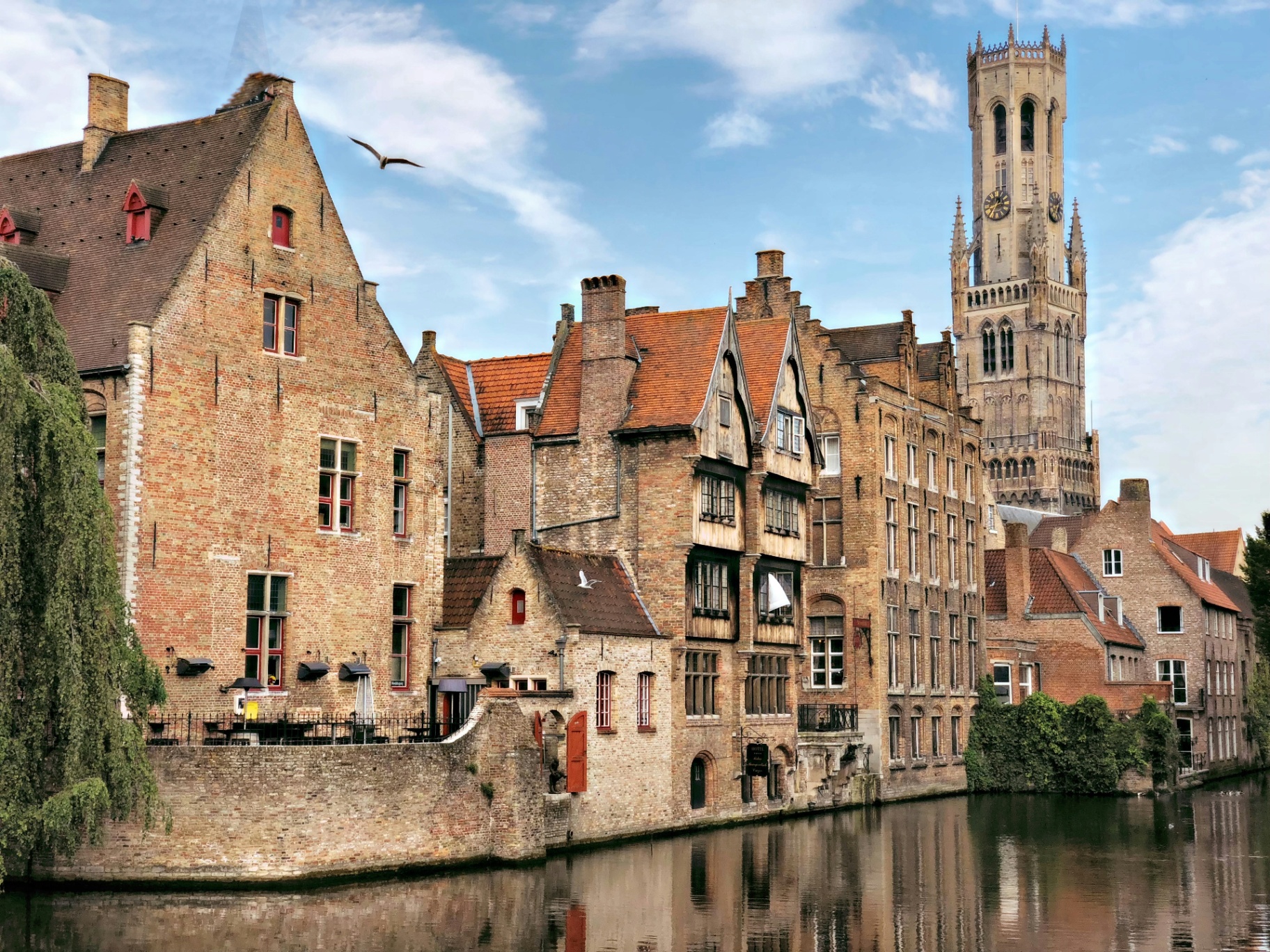 Rozenhoedkaai canal view in Bruges Belgium with Belfry tower